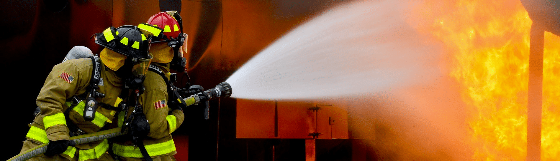 Firefighters spraying water on blaze metaphor for crisis response work